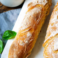 Zwei Baguettes auf einem Marmorbrettchen.